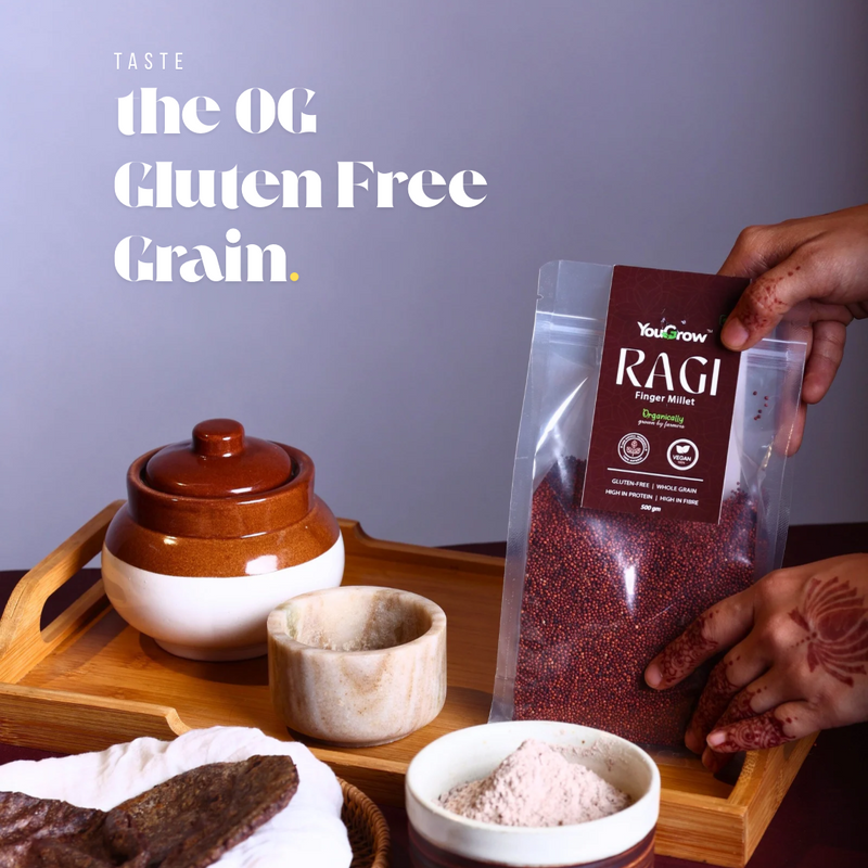 Ragi packaging with traditional kitchen items on a wooden tray.