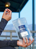 Woman holding a package with a scenic background